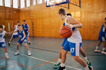 Junior basketball team in action playing basket at training.