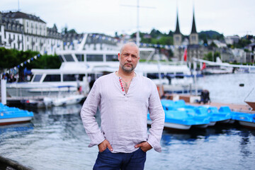 Handsome young man on Luzern lake's shore