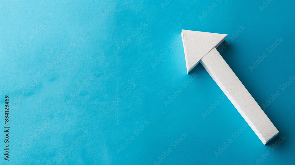 Aufkleber Simple concept with a white paper arrow pointing up on a textured blue background