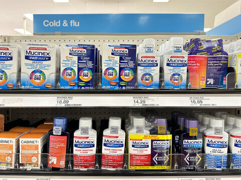 Mucinex cold, flu and cough medicine packages in a Target store pharmacy section