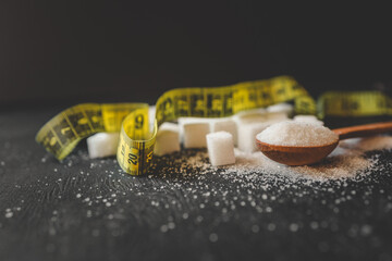 Sugar and measuring tape, health concept
