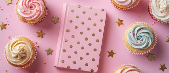 Pink table with cupcakes and notebook