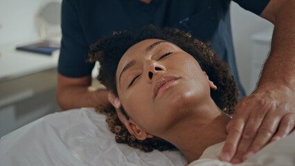 Patient doing recovery treatment on chiropractor session. Closeup woman lying