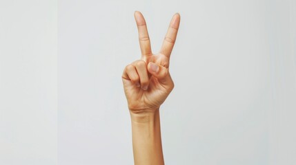hand of a woman making the peace sign on white background