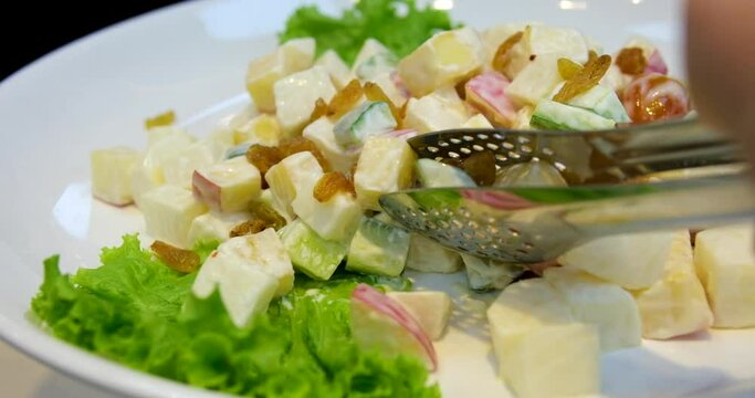 picking up potato salad buffet in a restaurant Olivier russian salad -a classic recipe with mayonnaise, an incredible taste, homemade recipe.