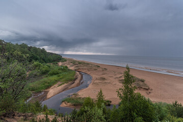 View to the baltic sea and Incupe river from Saulkrasti white dune, Latvia on rainy day