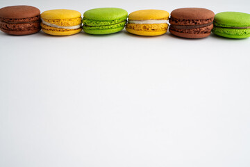 Colorful macarons arranged neatly on a white table
