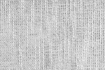 Jacquard woven coarse weave texture upholstery white fabric. Textile background, furniture textile material, wallpaper, backdrop. Cloth structure close up, macro.