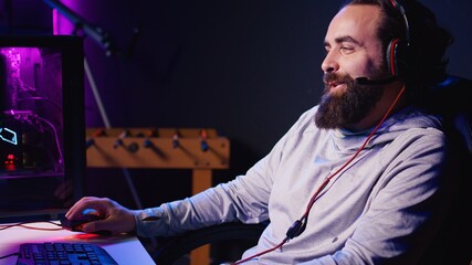 Man talking with friends online while playing singleplayer videogame with spaceship shooting laser...