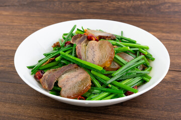 A dish of fried leek moss with bacon