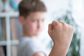 aggressive child with Attention deficit hyperactivity disorder threatening with fist, Social...