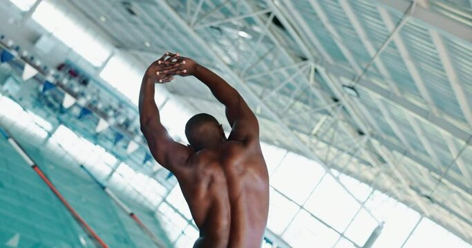 Back, stretching and black man swimmer at pool for fitness, training or water sports in gym. Body, exercise and health with warm up of professional athlete swimming for competition or wellness