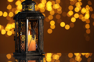 Arabic lantern on mirror surface against blurred lights, space for text
