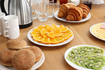 Different meals served on wooden table indoors. Buffet menu