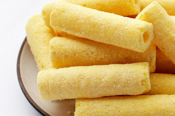 Roller corn snack on white background