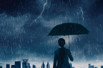 Rear view of female entrepreneur holding an umbrella while standing under rain storm