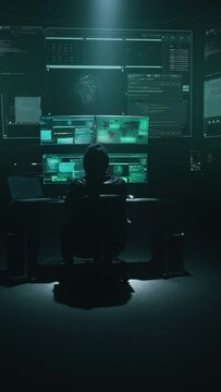 Minimalistic concept vertical shot hacker surrounded by programming codes interface in a dark ambient cyber space, sitting at a table with monitors doing hacking attack steals secret government data.