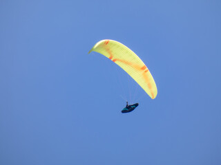 paragliding in the blue sky