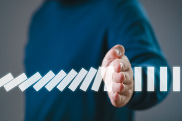 Hand Stopping the digital domino business crisis effect or risk protection concept, business solve...