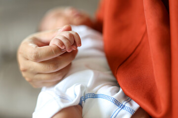 Close Up Photo Of Mother Holds The Baby Hand In Her Arms