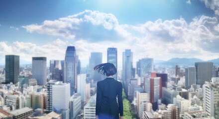 Fototapeta premium 日本の街・都市・朝日を受けたオフィスビル群を前に佇み風を受けて髪をなびかせる会社員の女性の出勤 就職・ビジネス・はじまり・決意・目標・挑戦のイメージ