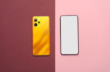 Smartphone mockup back and front view on pink burgundy background. Top view