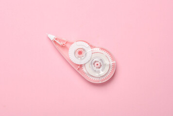 Tape corrector on pink background. Top view