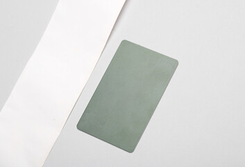 Fototapeta premium Receipt ribbon with credit card on a gray background. Mockup for design