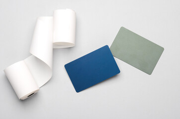 Receipt tape with credit cards on a gray background. Mockup for design