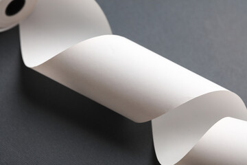 White blank Receipt tape on a dark gray background. Mockup for design