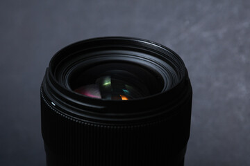 Professional lens on a black background. Photographer's equipment