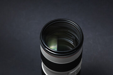 Professional lens on a black background. Photographer's equipment