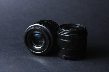 Professional photographic or videographic lenses on a black background. Photographer's equipment