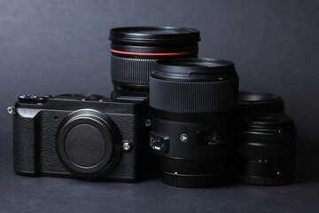 Professional camera with lenses on a black background. Equipment for photographer or videographer