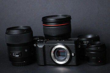 Professional camera with lenses on a black background. Equipment for photographer or videographer