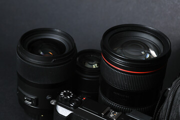Professional camera with lenses on a black background. Equipment for photographer or videographer