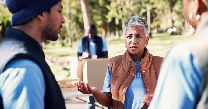 Women, volunteer and discussion with clipboard in park for community service, planning and support. NGO, idea and mature manager with teamwork in nature for charity project, collaboration or donation