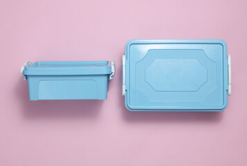 Blue Plastic containers for storing food on a pink background. Top view