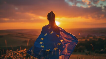A woman wrapped in the European flag, facing a colorful sunset