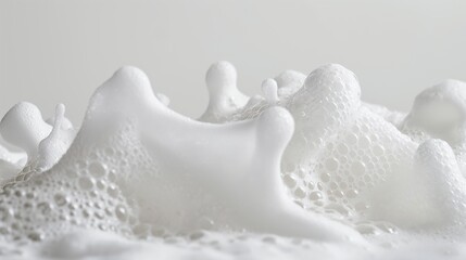 White soap foam isolated on a white background, capturing the clean and airy texture of the foam