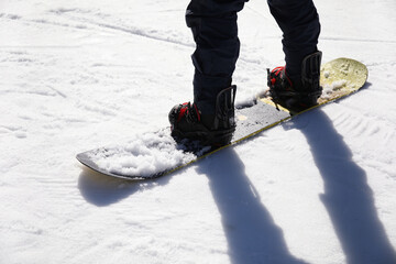 Male snowboarder on ski piste at snowy resort