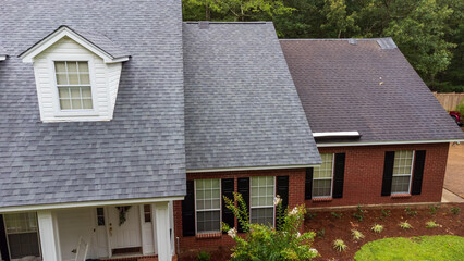 New roof and old roof on house, showing comparison of the two.