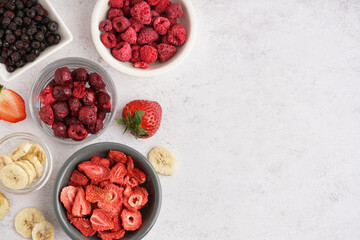 Bowls with freeze-dried fruits on white background
