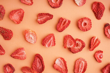 Tasty freeze-dried strawberries on orange background