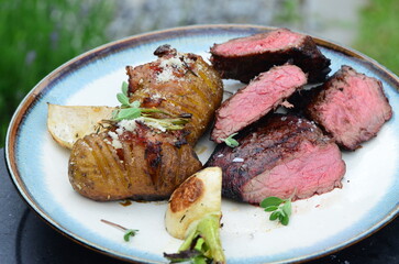 closeup grilled beef meat with vegetables and baked potatoe