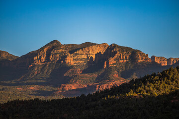 Fototapeta premium Desert mountain landscape at sunset with dramatic lighting and clear skies