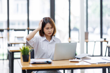 Fototapeta premium asian woman work at laptop thinking of problem solution, thoughtful female employee pondering considering idea looking at computer screen making decision 