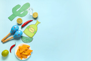 Mexican maracas with nachos, limes and chilli on blue background. Cinco de Mayo