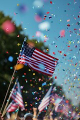American flag waving at a patriotic outdoor celebration with colorful confetti and clear blue sky.