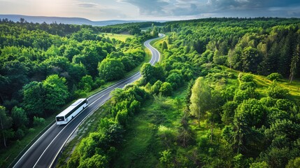 A tranquil highway curves through a vibrant green forest, showcasing a white travel bus on its route. The scene, captured in wide-angle, 70mm focus, emphasizes the peaceful journey and vivid hues.